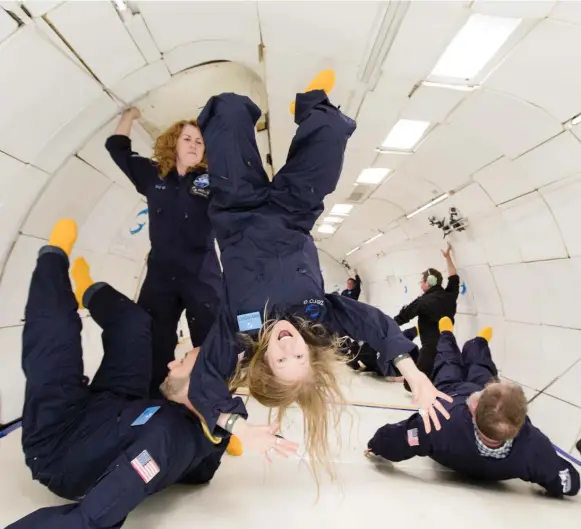  ?? STEVE BOXALL/ZERO GRAVITY CORP. ?? Author Leigh Ann Henion and fellow passengers experience weightless­ness aboard G-Force One. To be weightless is to be suspended in a visceral sense of eternity, Henion writes.