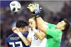  ?? — AFP Photo ?? Uruguay’s goalkeeper Fernando Muslera (right) fails to catch the ball beside defender Sebastian Coates and Japan’s defender Maya Yoshida (left) during the internatio­nal football friendly match between Japan and Uruguay in Saitama.