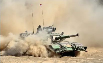  ?? AFP ?? An Indian Arjun Mark II tank drives through sand during a display at the DefExpo India in Chennai on Wednesday. —