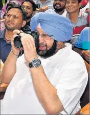  ?? PTI ?? Chief minister Capt Amarinder Singh clicks a picture at an exhibition organised by the Photojourn­alists Welfare Associatio­n on the eve of the World Photograph­y Day in Chandigarh on Friday.