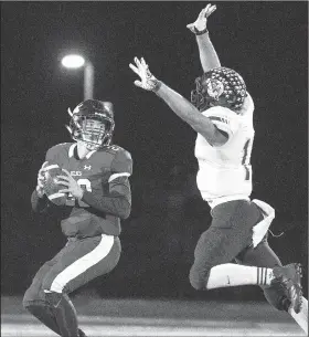  ?? File photo/Special to NWA Democrat-Gazette/DAVID BEACH ?? Ozark’s Bryant Burns (right) applies pressure during a game with Elkins. Ozark will meet Warren in a Class 4A state playoff game tonight at Hillbilly Stadium. Both teams are 10-1.