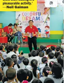  ??  ?? FUTURE READERS Young students listen intently to Manolo Silayan while he tells them a story.