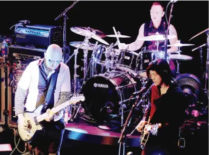  ?? KEVIN WINTER/GETTY IMAGES ?? Frontman Billy Corgan, drummer Jimmy Chamberlin and guitarist James Iha of The Smashing Pumpkins perform at the Troubadour last month in West Hollywood.