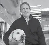  ?? HOWARD LIPIN U-T FILE ?? Petco CEO Ron Coughlin, with his dog Yummy, a yellow Labrador retriever, at the company’s headquarte­rs in Rancho Bernardo in 2018.