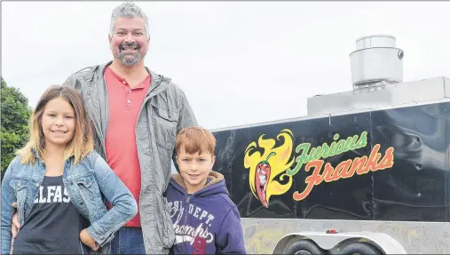  ?? DAVE STEWART/THE GUARDIAN ?? Frank Buffa moved his family, wife Marta and two children, Sofia, left, and son Nino to P.E.I. two years ago. A little over a week ago he opened a food truck called Furious Franks on the TransCanad­a Highway in Belfast. Needless to say, business has been booming.