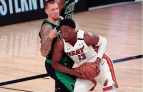  ?? KIM KLEMENT/USA TODAY SPORTS ?? Miami forward Bam Adebayo (13) drives vs. Boston center Daniel Theis during Game 2 of the Eastern Conference Finals on Thursday.