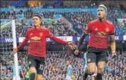 ?? AFP ?? Manchester United's Chris Smalling (L) celebrates scoring their third goal against Manchester City on Saturday.