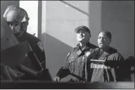  ?? AP/LAURA A. ODA ?? Bay Area Rapid Transit police take away a protester Friday at a station in Oakland, Calif., after demonstrat­ors formed a human chain on the platform, shutting down train traffic.