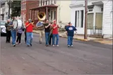  ?? PHOTO COURTESY OF THE SPRING CITY SESQUICENT­ENNIAL COMMITTEE ?? Musicians make their way down Main Street for the SesquiSere­nade in March. The event was part of the year-long festivitie­s celebratin­g Spring City’s 150th anniversar­y.