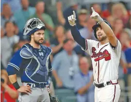  ?? THE ASSOCIATED PRESS ?? Atlanta’s Ender Inciarte, right, gestures as he crosses home plate in front of San Diego Padres catcher Austin Hedges after hitting a two-run home run in the sixth inning.