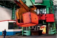  ?? — AFP ?? An employee walks past red hot steel at a plant in China’s eastern Shandong province.