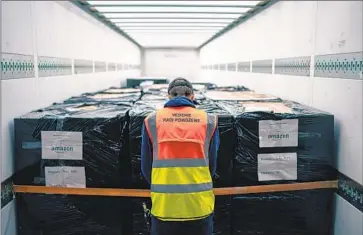  ?? Amazon ?? AN AMAZON worker readies humanitari­an supplies for Ukraine. The company is also transporti­ng important cargo out of the country: computer storage units containing government, tax, banking and property data.