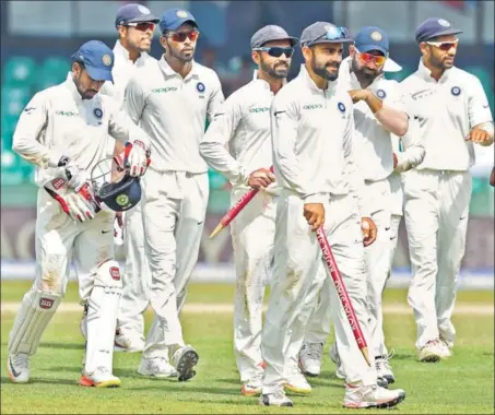  ?? AFP ?? Skipper Virat Kohli leads the team out after India recorded their eighth consecutiv­e series victory. India beat Sri Lanka by an innings and 53 runs in Colombo on Sunday.