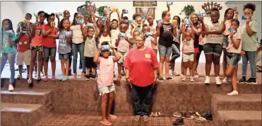  ??  ?? Youth at the 4C’s camp in Polk County held up snacks donated by God’s Loving Angels during a midweek visit.