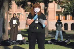  ??  ?? Sharli Schaitberg­er, with Indivisibl­e Phoenix, speaks at the rally hoping to dissuade the governor from reopening Arizona too quickly amid the pandemic.