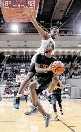  ?? Michael Wyke / Contributo­r ?? Morton Ranch's L.J. Cryer, top, reaches to defend a shot by Yates’ Jabraylon Vaughn during the second half of a basketball game Saturday in Houston.