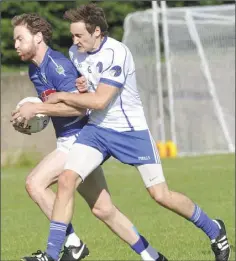  ??  ?? David Quigley of Roche Emmets is challenged by Brian McGuinness of Lannleire.