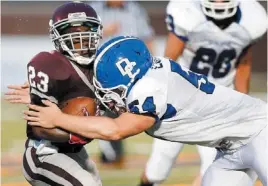  ??  ?? Deer Creek’s Austin Loomis tackles Edmond Memorial’s Waylan Anderson Thursday night in the Antlers’ 45-14 win. Loomis recorded 30 tackles in the game.