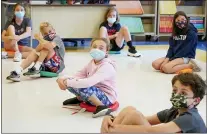  ?? MARY ALTAFFER — THE ASSOCIATED PRESS FILE ?? Fifth graders wear masks and sit at proper social distancesp­acing during a music class at the Milton Elementary School in Rye, N.Y. As more children go back to the physical classroom, families are expected to spend robustly on a wide range of items, particular­ly trendy clothing for the critical back-to-school season, according to one key spending measure.