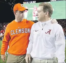  ?? Getty Images ?? CLEMSON’S DABO SWINNEY and Alabama’s Nick Saban meet before the 2017 national championsh­ip game. The teams will meet for a fourth consecutiv­e year.