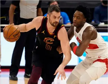  ?? AP Photo/Chris O’Meara ?? Cleveland Cavaliers forward Kevin Love (0) drives around Toronto Raptors forward OG Anunoby (3) during the first half of an NBA basketball game on Monday in Tampa, Fla.