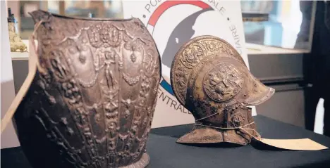  ?? THOMAS SAMSON/GETTY-AFP ?? A breastplat­e and ceremonial helmet stolen from the Louvre 38 years ago have been found.