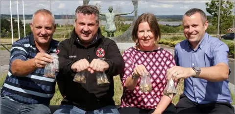  ??  ?? Show me the money: Colm Hearne of Hearne Constructi­on, Cllr. George Lawlor and Sonia Hunt and Michael Brazzil of Wexford County Council with the coins.