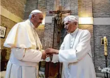  ?? L’Osservator­e Romano 2017 ?? Pope Francis (left) greets Pope Emeritus Benedict XVI on the occasion of the elevation of new cardinals at the Vatican in 2017.