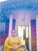  ?? ?? Anju stands in front of her and Amar Padiachi’s Stratford home which was decorated with plenty of lights for the Diwali celebratio­ns.