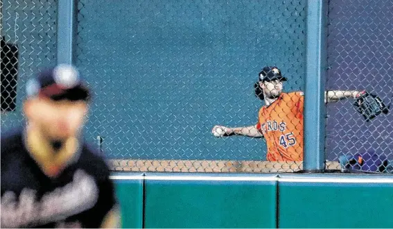  ?? Brett Coomer / Staff photograph­er ?? Warming up as soon as the fifth inning Wednesday night, Astros ace Gerrit Cole was clearly prepared to make his first career relief appearance. A call never came.