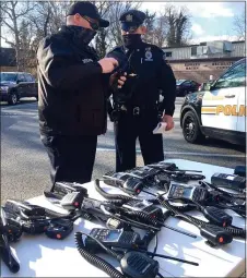  ?? PETE BANNAN - MEDIANEWS GROUP ?? Delaware County Emergency Services Training Officer Dannon Voight talks with Darby Police Officer K. Collins about features of the new radios.