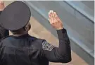  ?? MIKALA COMPTON/AMERICAN-STATESMAN ?? Police cadets raise their hands as they take the oath of office during the Austin Police Department’s commenceme­nt ceremony Jan. 5. A contract between the city and Austin’s police union is considered a key component to attract recruits and retain officers.