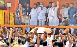  ?? — R. PAVAN ?? Prime Minister Narendra Modi waves to the public at Begumpet airport on Thursday. BJP state president Bandi Sanjay, Union minister G. Kishan Reddy, Vijayashan­ti and others are also seen.