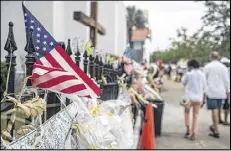  ?? GETTY IMAGES ?? People walk past Emanuel AME Church in Charleston, S.C., on Friday. Earlier, Dylan Roof was arraigned on 33 charges, including hate crimes, in the June 17 massacre.