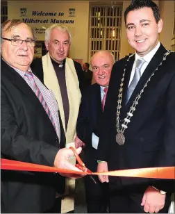  ??  ?? Chairman Millstreet Community Council Noel Buckley cuts the tape to re-open the newly refurbishe­d Millstreet Museum in 2015 in the presence of then County Mayor John Paul O’Shea, Canon John Fitzgerald and Seán Radley, curator.