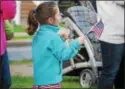  ??  ?? A girl waves an American flag during the Oneida Memorial Day parade on Friday, May 26, 2017.