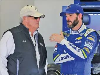  ?? THE ASSOCIATED PRESS ?? Car owner Rick Hendrick, left, and NASCAR driver Jimmie Johnson talk in the garage Friday at Daytona Internatio­nal Speedway. Johnson, 41, added a record-tying seventh Cup Series championsh­ip last season.