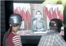  ?? AUNG SHINE OO/AP ?? Peoples watch a televised speech by Myanmar’s State Counsellor Aung San Suu Kyi, by a roadside Thursday in Naypyitaw, Myanmar.