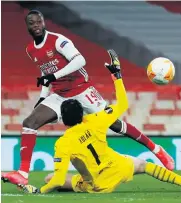  ??  ?? Close call: Arsenal’s Nicolas Pepe beats Slavia Prague’s Ondrej Kolar to open the scoring last night