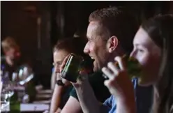  ??  ?? In this photo customers use cups cut from glass collected as waste on Mount Everest, at a restaurant in Kathmandu.