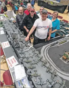  ?? ?? The Lochaber team of modellers with the large scale Ark Royal covered in aircraft which traces the history of naval aviation.