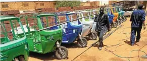  ?? — Photos: AFP ?? Workers assembling electric tuk-tuks at al-shehab factory in the sudanese capital’s northern district of Khartoum-bahri, recently.