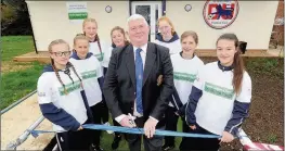  ??  ?? OPEN DAY: Chief executive of the Middlesex FA Peter Clayton cuts the ribbon with Denham players