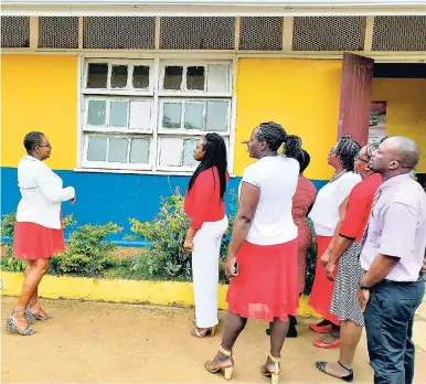  ?? CONTRIBUTE­D ?? Principal of Simon Primary and Infant School, Nova-Dean Samuels-Lee (left), shares with her team her vision of painting murals as part of efforts to improve the physical appearance of the school.