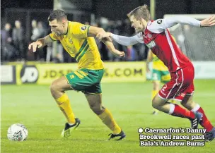  ??  ?? Caernarfon’s Danny Brookwell races past Bala’s Andrew Burns