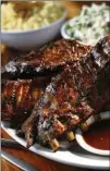  ?? STUDIO CONTRIBUTE­D BY HAIGWOOD ?? Swallow at the Hollow serves up tasty barbecue classics like ribs and mac and cheese in historic Roswell.