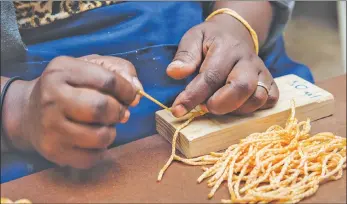  ??  ?? A partnershi­p with Distell has provided a regular income for Handwork Hub workers, who make the tassels for Amarula bottles.