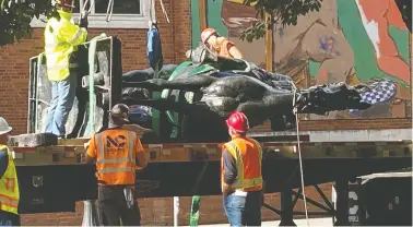  ?? TOM BLACKWELL/NATIONAL POST ?? Workers cart away a statue of Theodore Roosevelt after protesters pulled it down in a Portland, Ore. The city, as the centre of America's anti-racism movement, became a focus of President Donald Trump's re-election campaign.