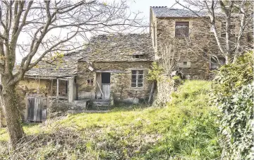  ??  ?? Gustavo Iglesias’ village, Acorrada, in the northern Spanish region of Galicia. Iglesias moved to a larger town for work, leaving behind a village with six stone houses and two grain stores, overlookin­g a lush valley.