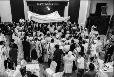  ?? Photo by Heidi Paster Harf ?? A marriage ceremony after a group conversion to Judaism; many participan­ts later discovered their conversion would not be recognized for the purpose of immigratin­g to Israel.